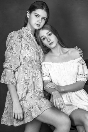 Brunette and blonde posing in dark studioの写真素材