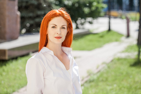 Portrait of middle aged woman with dyed red hair