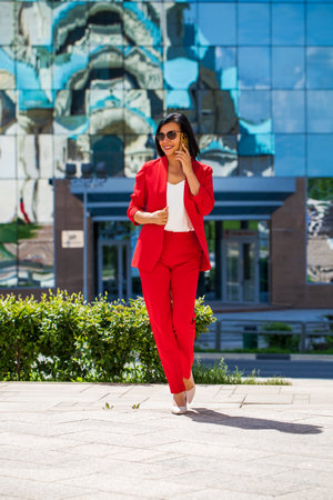 Happy beautiful business woman calling by phoneの写真素材