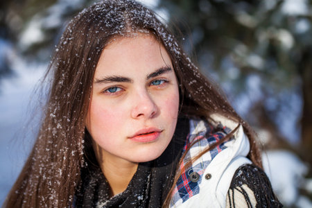 Portrait of a young beautiful girl in a winter parkの写真素材