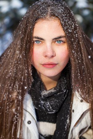 Winter portrait of a young beautiful brunette womanの写真素材