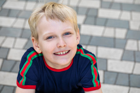 Portrait of a little boy posing in a summer park