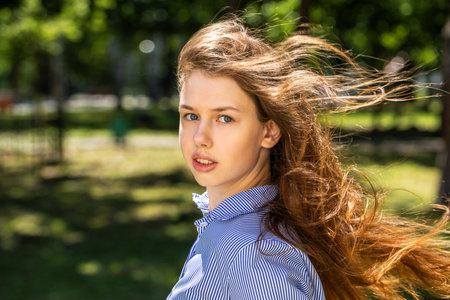 Close up portrait of a young tenager, summer park outdoorsの写真素材
