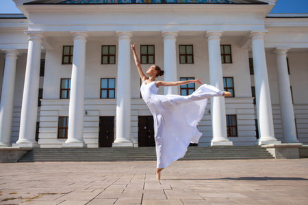 Full-length portrait of a Russian ballerina in a white long skirtの写真素材