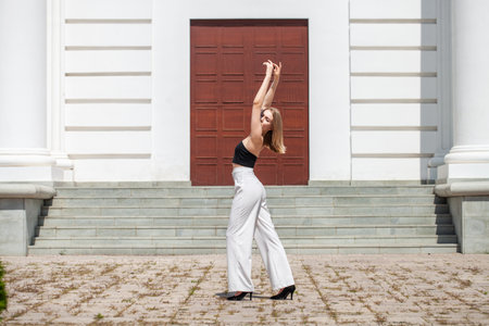 Full length portrait of a young girl in white pantsの写真素材
