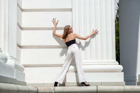 Full length portrait of a young girl in white pantsの写真素材