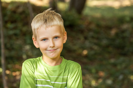 Close up portrait of a little boy, outdoorsの写真素材