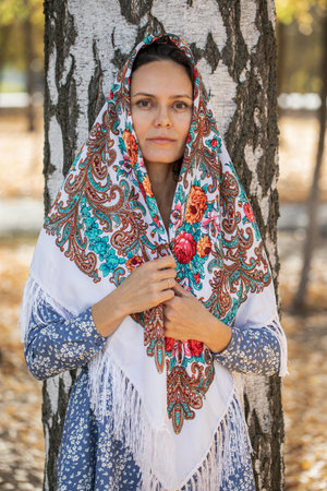 Slavyanka - Russian beauty. Portrait of a middle-aged woman in a traditional patterned headscarf