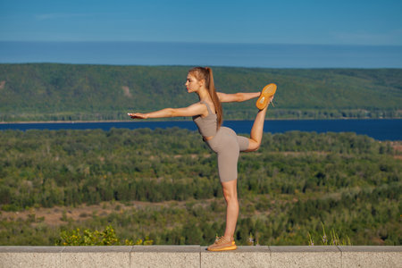 Fitness portrait young athletic woman doing gymnasticsの写真素材