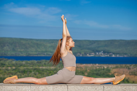 Fitness portrait young athletic woman doing gymnasticsの写真素材