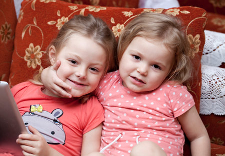 Couple happy sisters at homeの写真素材