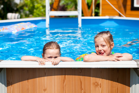 Two Happy sisters swimming poolの写真素材