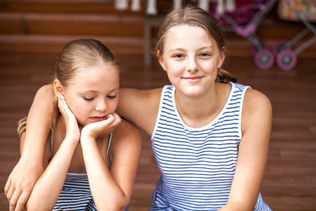 Close up portrait of two young beautiful sistersの写真素材