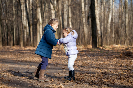 Couple sisters in autumn parkの写真素材