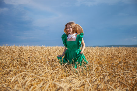 Portrait of a young blonde woman posing in a wheat fieldの写真素材