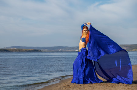 Young woman posing in oriental dance costumeの写真素材