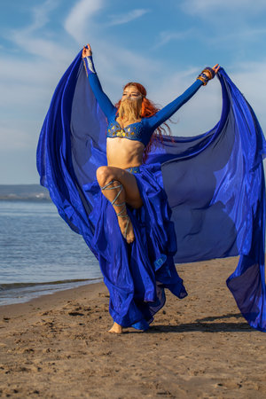Young woman posing in oriental dance costumeの写真素材
