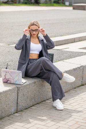 Portrait of a blonde girl in a pantsuitの写真素材