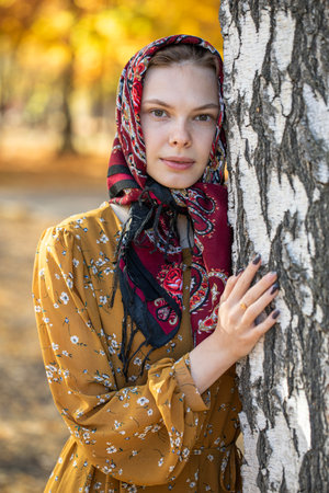 Portrait of a young beautiful girl with a scarf on her headの写真素材