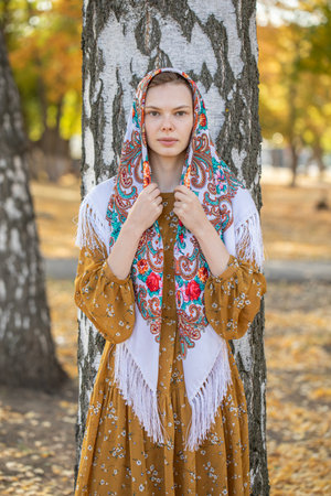 Portrait of a young beautiful girl with a scarf on her headの写真素材