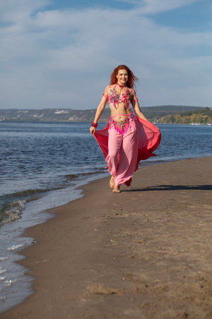 Portrait of a red-haired woman in an oriental dance costumeの写真素材