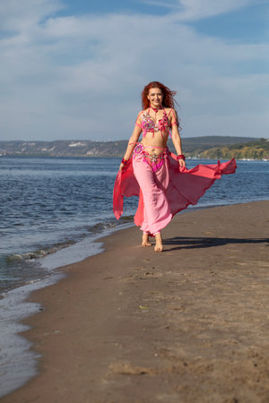 Portrait of a red-haired woman in an oriental dance costumeの写真素材