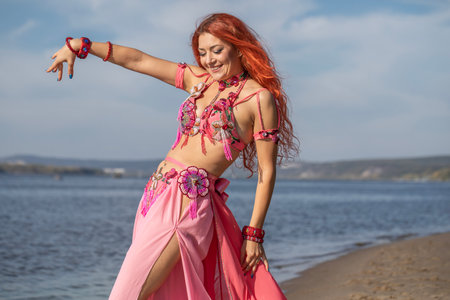 Portrait of a red-haired woman in an oriental dance costumeの写真素材