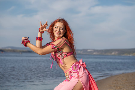 Portrait of a red-haired woman in an oriental dance costumeの写真素材