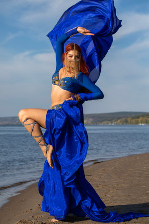Portrait of a red-haired woman in an oriental dance costumeの写真素材