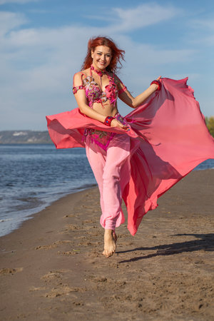 Portrait of a red-haired woman in an oriental dance costumeの写真素材
