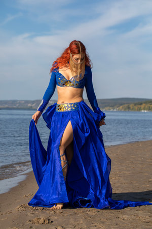 Portrait of a red-haired woman in an oriental dance costumeの写真素材