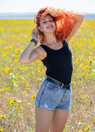Young beautiful woman posing in denim shortsの写真素材