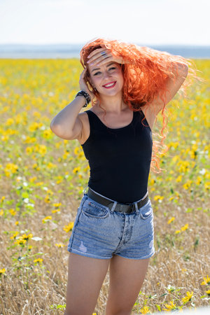 Young beautiful woman posing in denim shortsの写真素材
