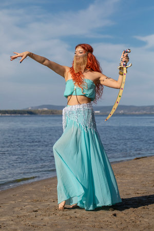 Portrait of a red-haired woman in an oriental dance costumeの写真素材