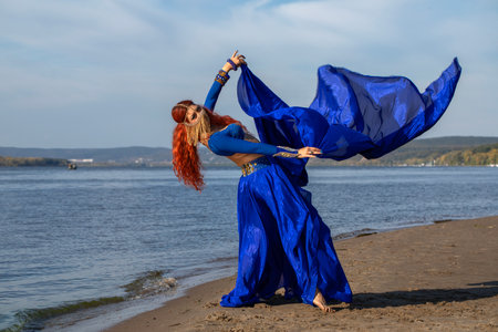 Portrait of a red-haired woman in an oriental dance costumeの写真素材