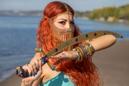 Portrait of a red-haired woman in an oriental dance costumeの写真素材