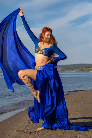 Portrait of a red-haired woman in an oriental dance costumeの写真素材