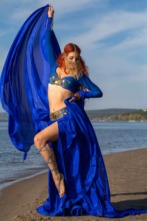 Portrait of a red-haired woman in an oriental dance costumeの写真素材