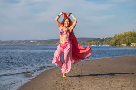Portrait of a red-haired woman in an oriental dance costumeの写真素材