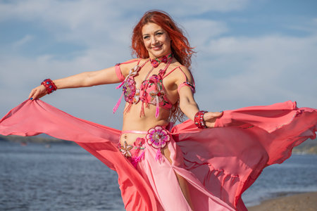 Portrait of a red-haired woman in an oriental dance costumeの写真素材