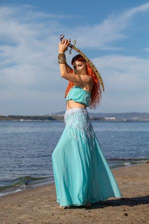 Portrait of a red-haired woman in an oriental dance costumeの写真素材
