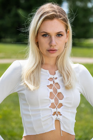 Young blonde girl posing in summer parkの写真素材