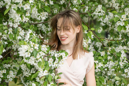 Young beautiful girl posing in a blooming gardenの写真素材