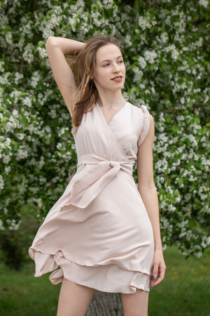 Young beautiful girl posing in a blooming gardenの写真素材