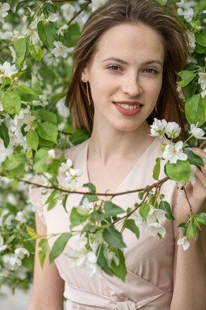 Young beautiful girl posing in a blooming gardenの写真素材