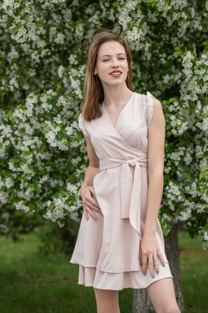 Young beautiful girl posing in a blooming gardenの写真素材