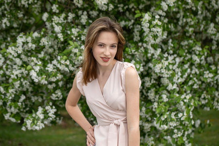 Young beautiful girl posing in a blooming gardenの写真素材