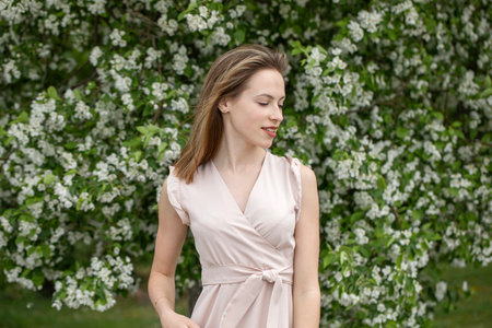 Young beautiful girl posing in a blooming gardenの写真素材
