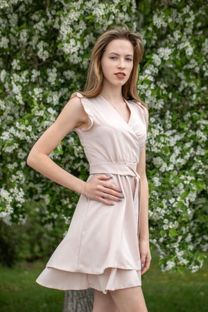 Young beautiful girl posing in a blooming gardenの写真素材