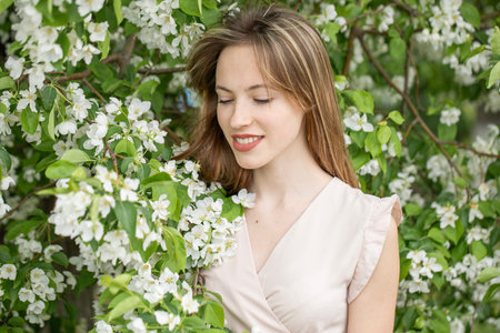 Young beautiful girl posing in a blooming gardenの写真素材